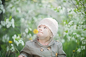 Funny girl with Down syndrome in the mouth pulls dandelions