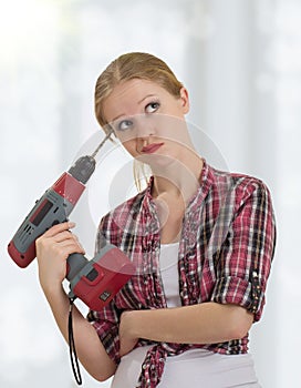 Funny girl with a drill drills head