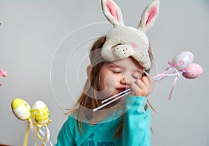 Funny girl with Easter colored eggs