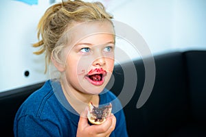 Funny girl eating bread roll with marmelade