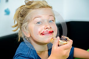 Funny girl eating bread roll with marmelade