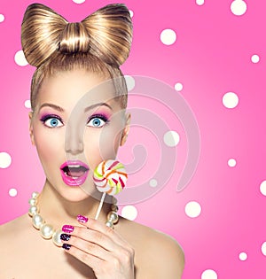 Funny girl eating lollipop photo