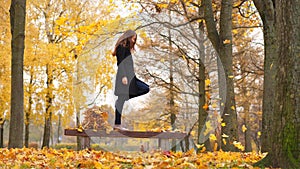 Funny girl kick yellow maple leaves
