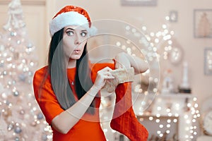 Funny Girl Looking for Her Gift in a Christmas Stocking