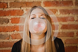 Funny girl making a pomp with a bubble gum