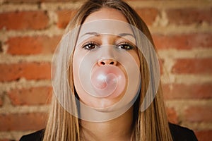 Funny girl making a pomp with a bubble gum