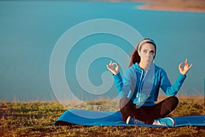 Funny Girl Meditating on Yoga Mat in Nature