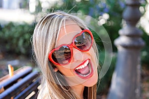 Funny girl with red heart glasses