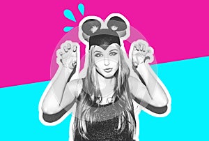 Funny girl represents a small cat or mouse. Woman with a bright makeup hairstyle and night dress mouse ears having fun