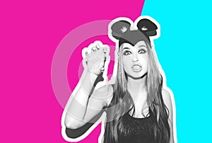 Funny girl represents a small cat or mouse. Woman with a bright makeup hairstyle and night dress mouse ears having fun