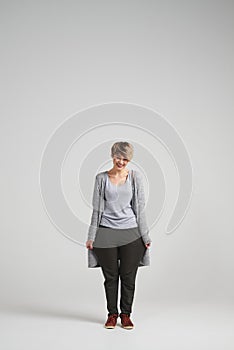 Funny girl with short haircut wearing baggy casual trousers