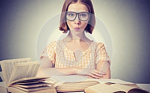 Funny girl student with glasses reading books