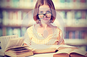 Funny girl student with glasses reading books