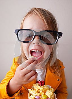 Funny girl with sweet popcorn and cinema glasses
