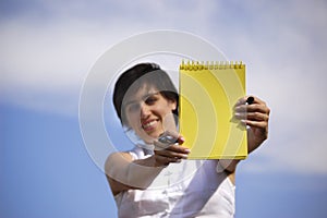 Funny girl with a yellow noteb