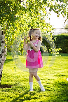 Funny girls walking on the lawn with her mother. Sisters play together with mom. maternal care. happy family