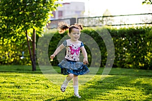 Funny girls walking on the lawn with her mother. Sisters play together with mom. maternal care. happy family