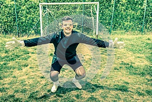 Funny goalkeeper at playground with stupid big empty glasses