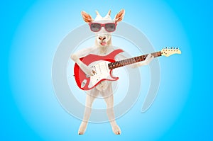 Funny goat showing tongue in sunglasses with electric guitar