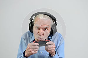 Funny grandfather playing a video game on console