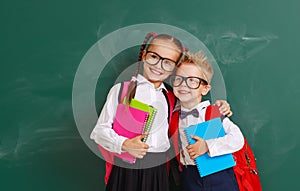 Funny group children   schoolboy  and schoolgirl, student boy  and girl about school blackboard