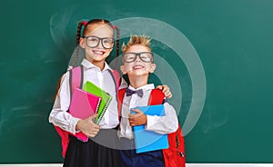 Funny group children   schoolboy  and schoolgirl, student boy  and girl about school blackboard