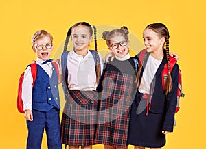 Funny group children  student boy  and girls about yellow background