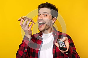 Funny Guy Eating Pizza And Holding Remote Control Watching Tv