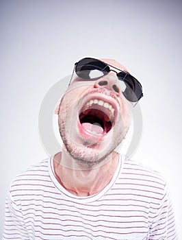 Funny guy wearing sun glasses screaming - fish eye shot