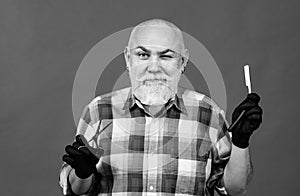 Funny hairdresser barber with scissors and razor. Portrait of stylish man bearded man with grey moustache beard.