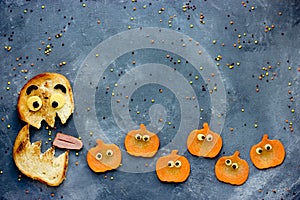 Funny Halloween food background bread monster eatsl pumpkin