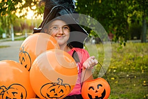 Funny Halloween kid in carnival costumes outdoors