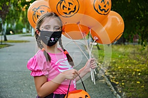 Funny Halloween kid in carnival costumes outdoors