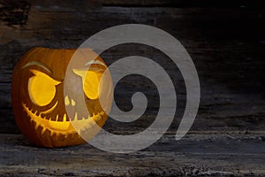 Funny Halloween pumpkin face with glowing candle.