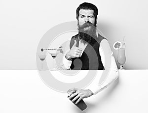 Funny handsome bearded barman on purple green studio background