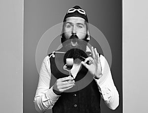 Funny handsome bearded pilot on colorful studio background
