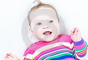 Funny happy baby girl wearing a pink knitted dress