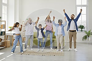 Funny, happy, cheerful family having fun and dancing all together in the living room