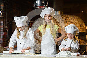 Funny happy chef boy width girl cooking at