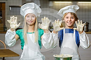 Funny happy chef boy width girl cooking at