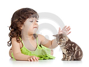 Funny happy child girl playing with cat kitten