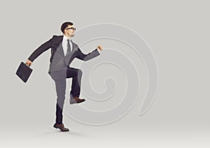 Funny happy corporate employee with business briefcase running to start his work day