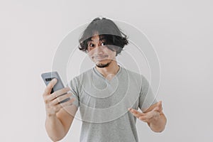 Funny and happy face of man look at his smartphone on white background.