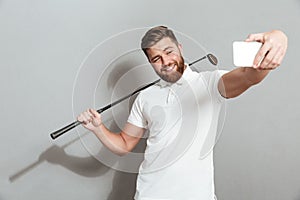 Funny happy golfer making selfie on his smartphone