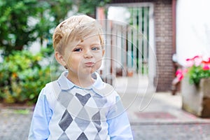 Funny happy and smiling kid boy on way to nursery