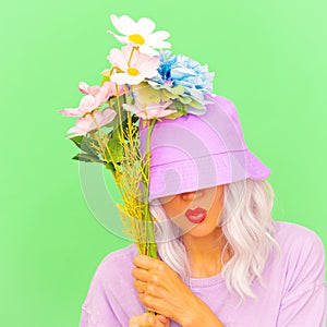 Funny hipster girl with flowers in trendy bucket hat.  Summer Kisses you