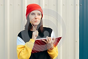 Funny Hipster Woman Writing Something Down in an Agenda