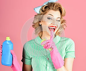 Funny housewife with cleaning sprayer. Housewife, isolated. Woman housekeeper in uniform with clean spray, sponge