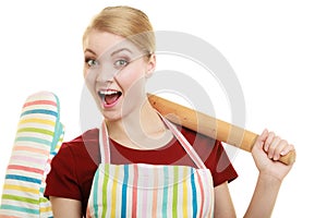 Funny housewife in kitchen apron holds baking rolling pin