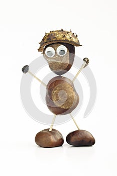 Funny human shape character or figurine made with chestnuts in w